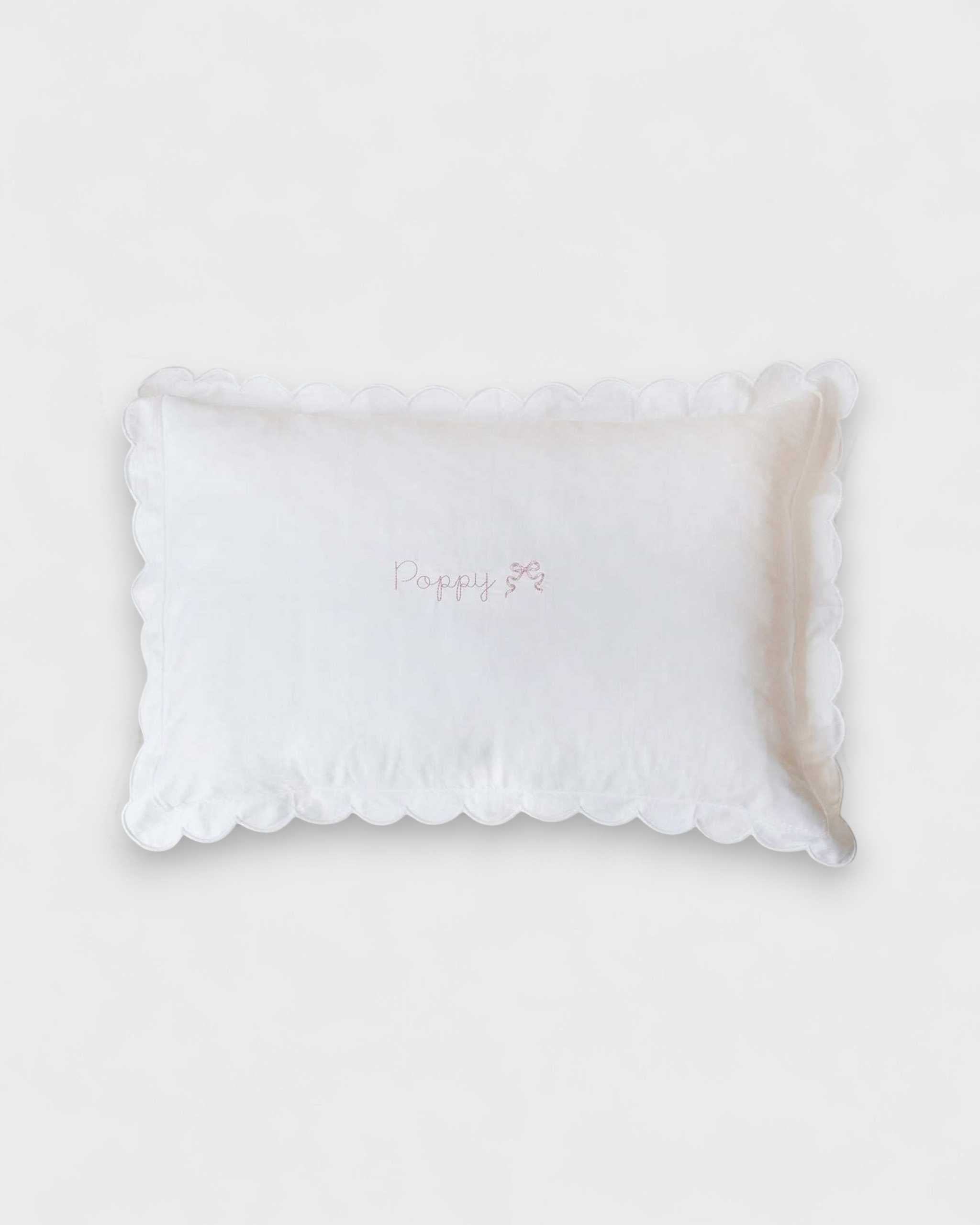 Organic cotton pillowcase with white scalloped edge and personalized embroidery.