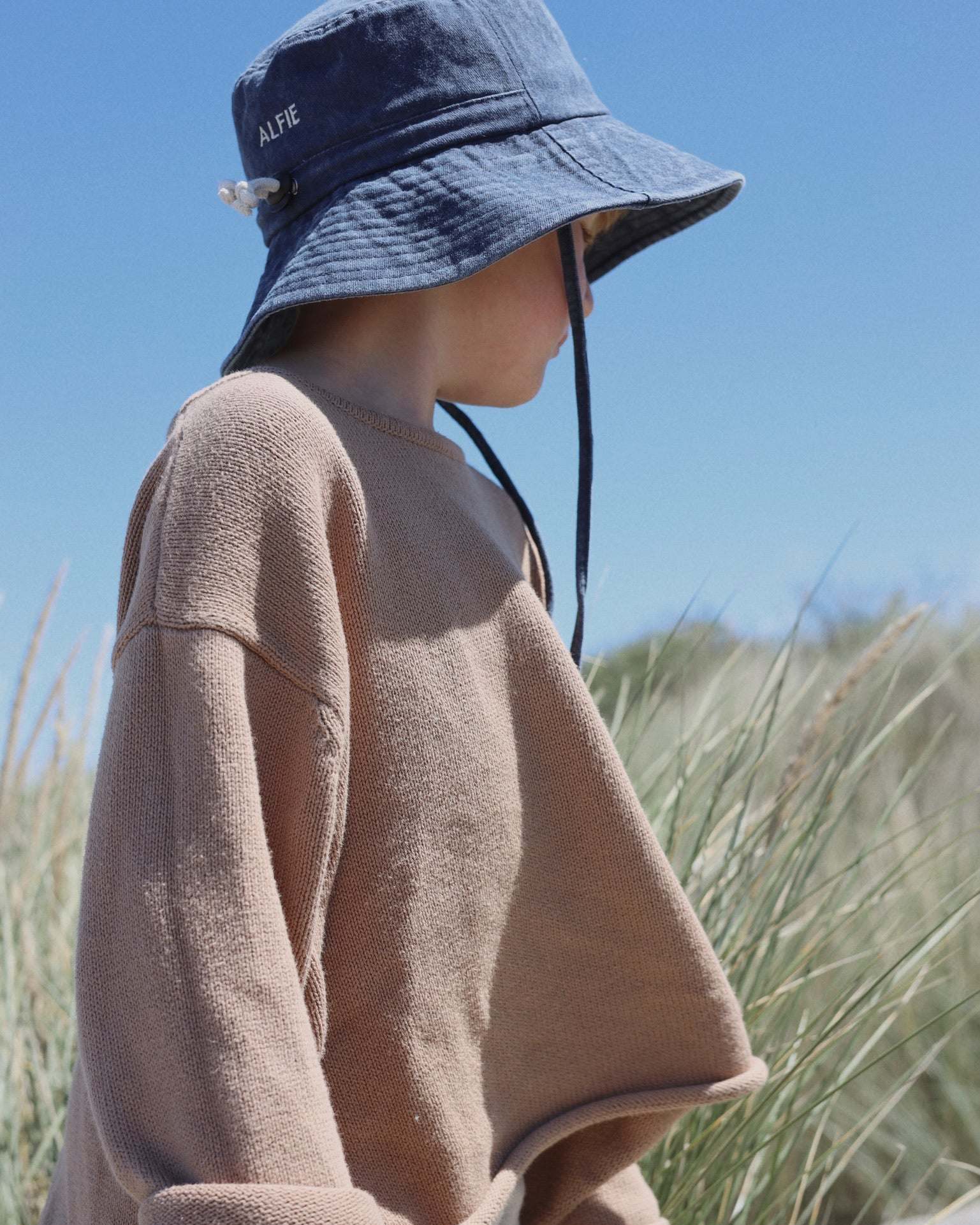 Child wearing Shells Personalised Bucket Hat outdoors.