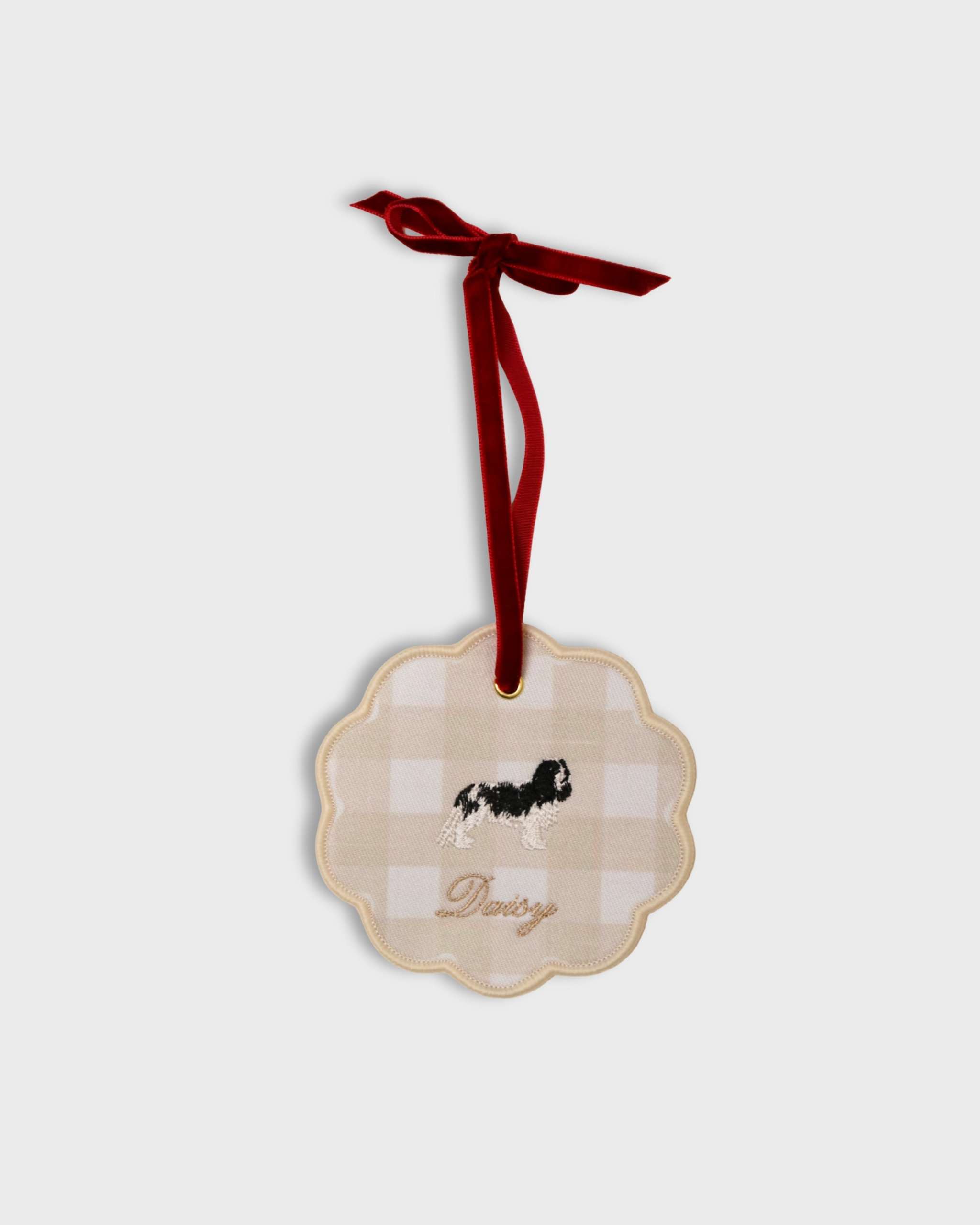 Custom pet ornament with embroidered dog and personalized name on gingham fabric with red velvet ribbon for hanging