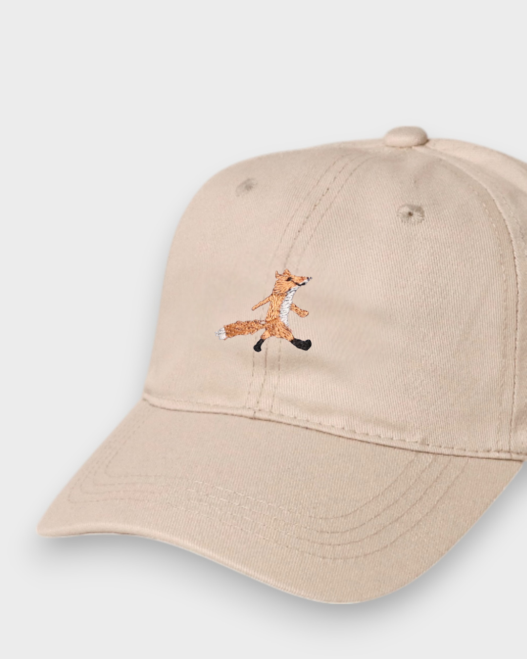 Cream baseball cap with hand-embroidered fox design and personalised back embroidery, 100% washed cotton.