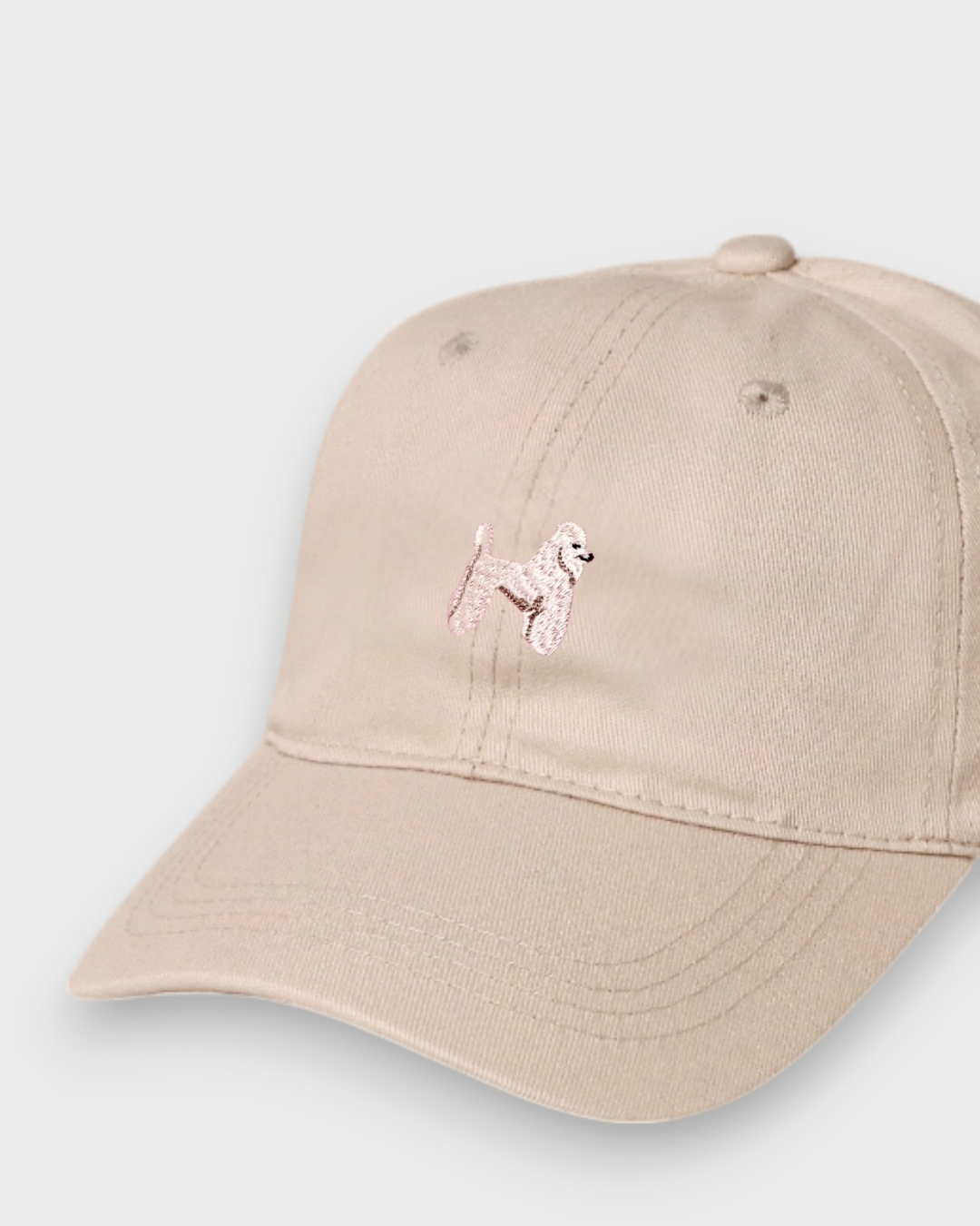 Beige Poodle Personalised Hat with hand-drawn embroidered poodle design, made from 100% washed cotton in classic baseball style.