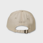 Beige personalised hat with embroidered name "ARLO" on the back and adjustable strap in a classic baseball fit