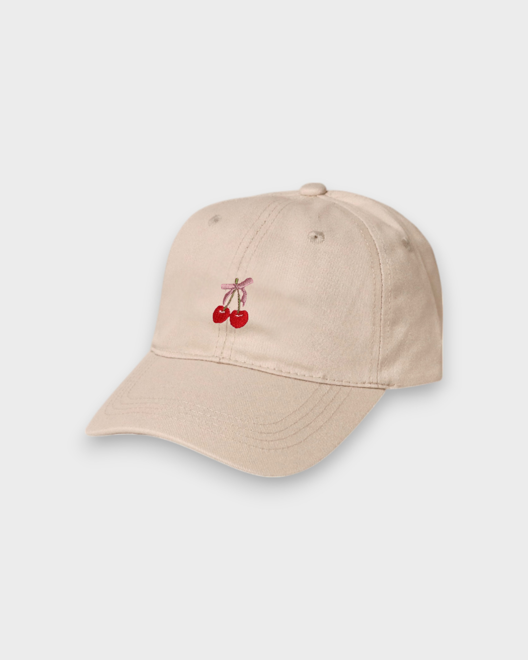 Beige personalised cotton baseball hat with embroidered cherries and pink bow on front
