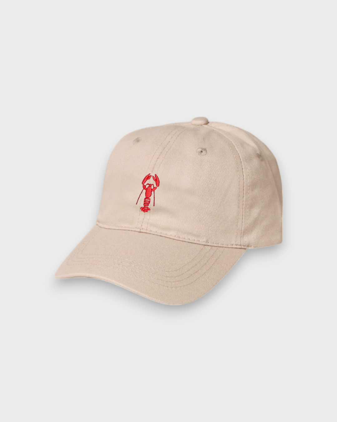 Beige baseball cap with red lobster embroidery and customizable back embroidery, made of 100% washed cotton.