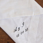 White cotton men's handkerchief with personalized embroidered initials and date on corner