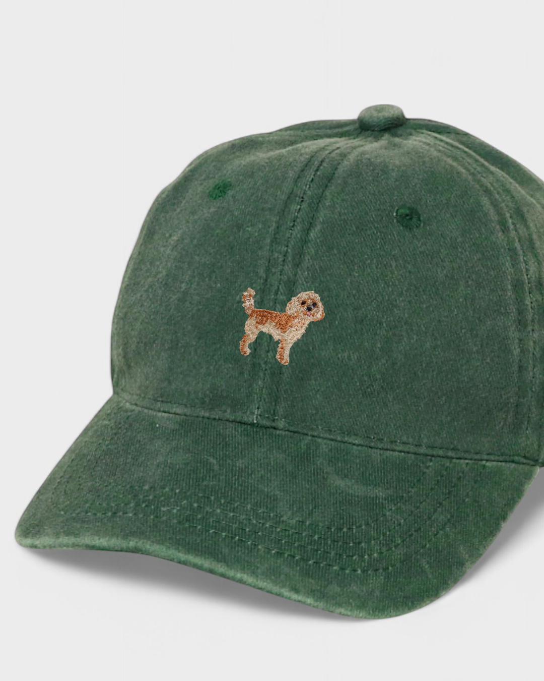 Green washed cotton baseball cap with hand-embroidered Cavoodle dog design, personalized embroidery option on the back.