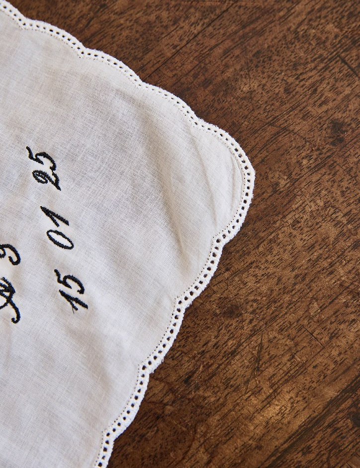 Delicate ladies handkerchief with scalloped edge and personalized embroidery on white cotton fabric