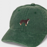 Green cotton baseball cap with embroidered Burmese Mountain Dog design on front, customizable embroidery on back.