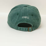 Green personalised hat with embroidered name "THEO" on the back, made of 100% washed cotton.