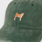 Green washed cotton baseball cap with embroidered Shiba Inu design on front, customizable with personalized embroidery on back