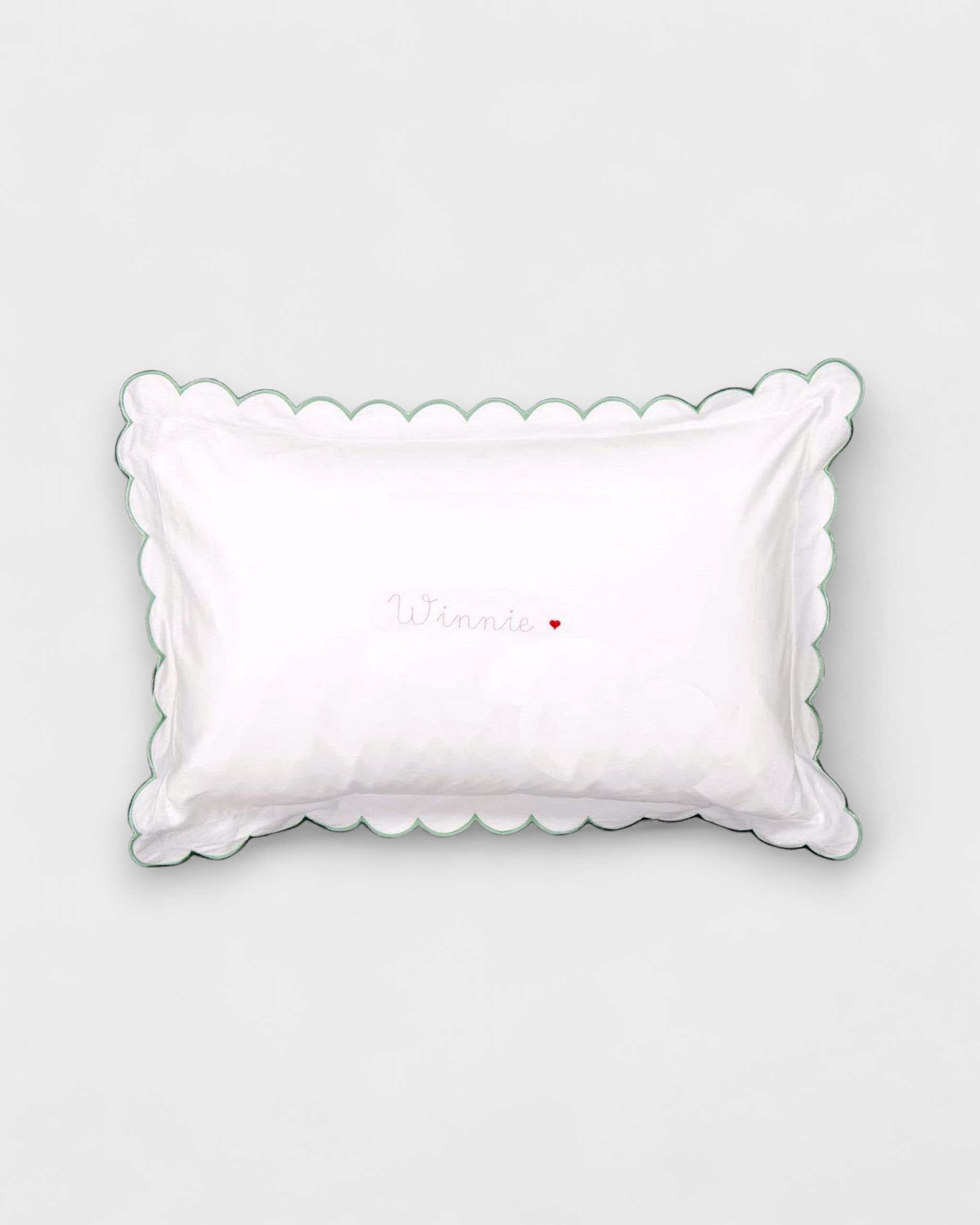 Organic cotton toddler pillowcase with sage scalloped edge and embroidered personalization.