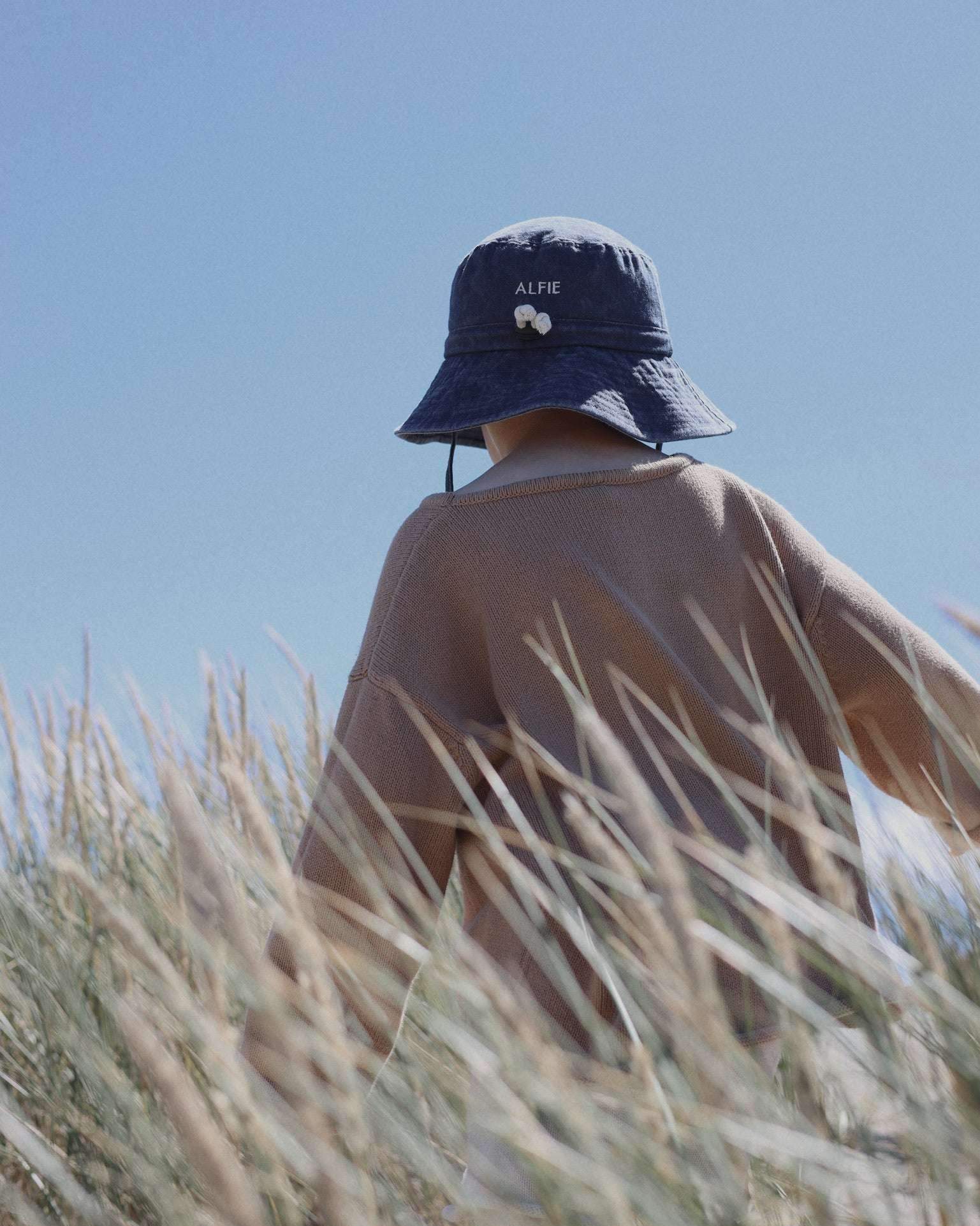 Shells Personalised Bucket Hat for kids, embroidered design, 100% washed cotton, suitable for ages 2-6, outdoor scene.
