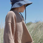 Child wearing Shells Personalised Bucket Hat outdoors.