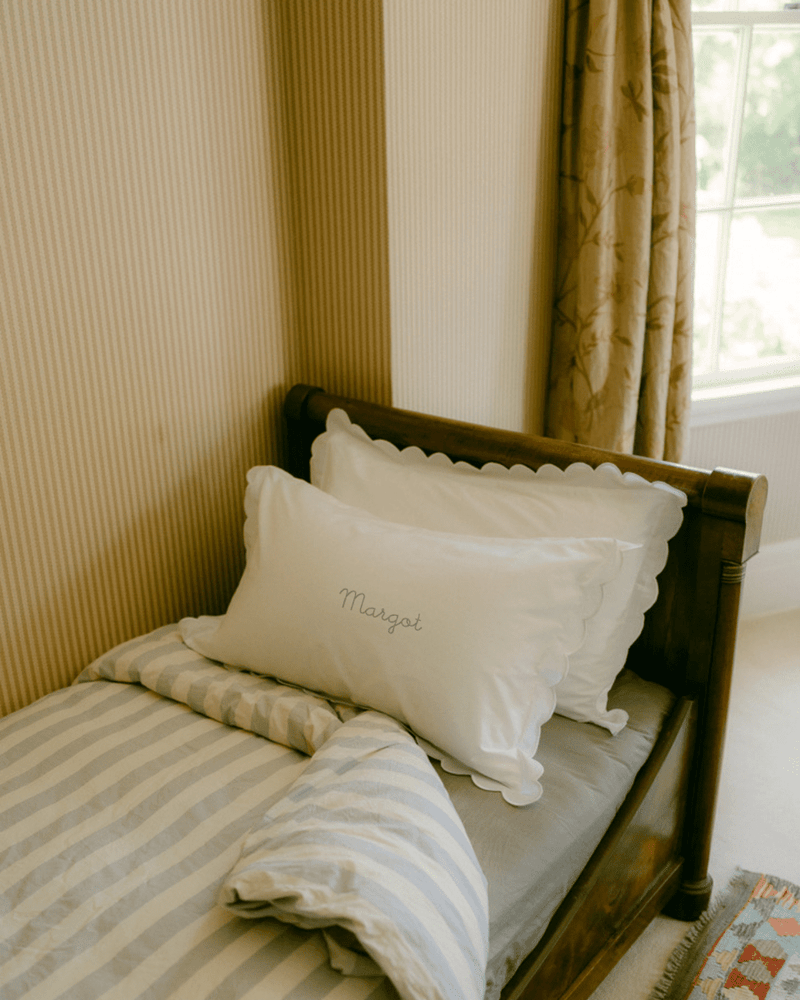 Person holding embroidered pillowcases